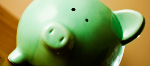 Picture of a green piggy bank, feature image for In defense of cost-effectiveness blog